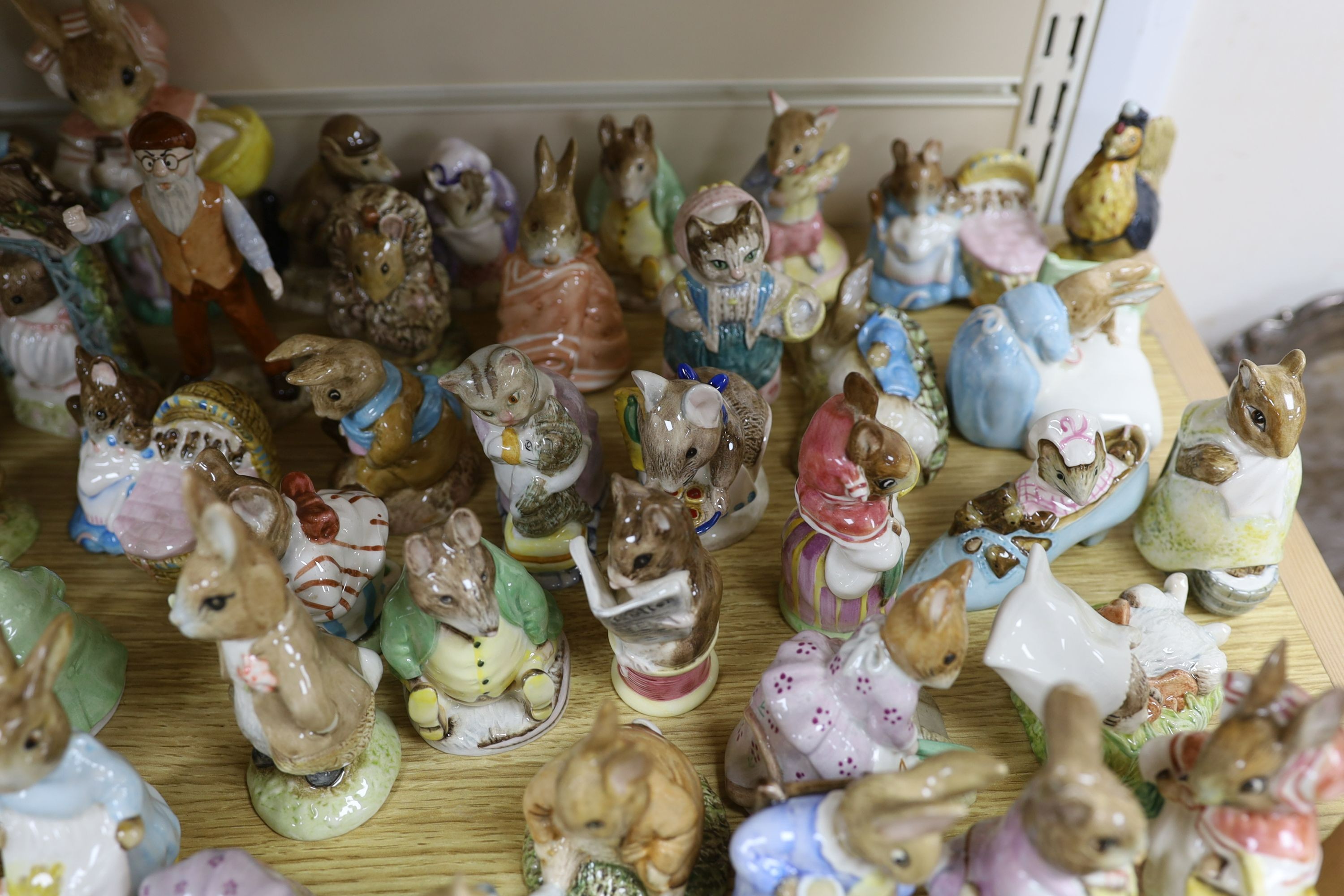 A large collection of Beatrix Potter ceramic figures by Royal Doulton, Beswick and Royal Albert, to include ‘Sir Isaac Newton’ and ‘Mr McGregor’